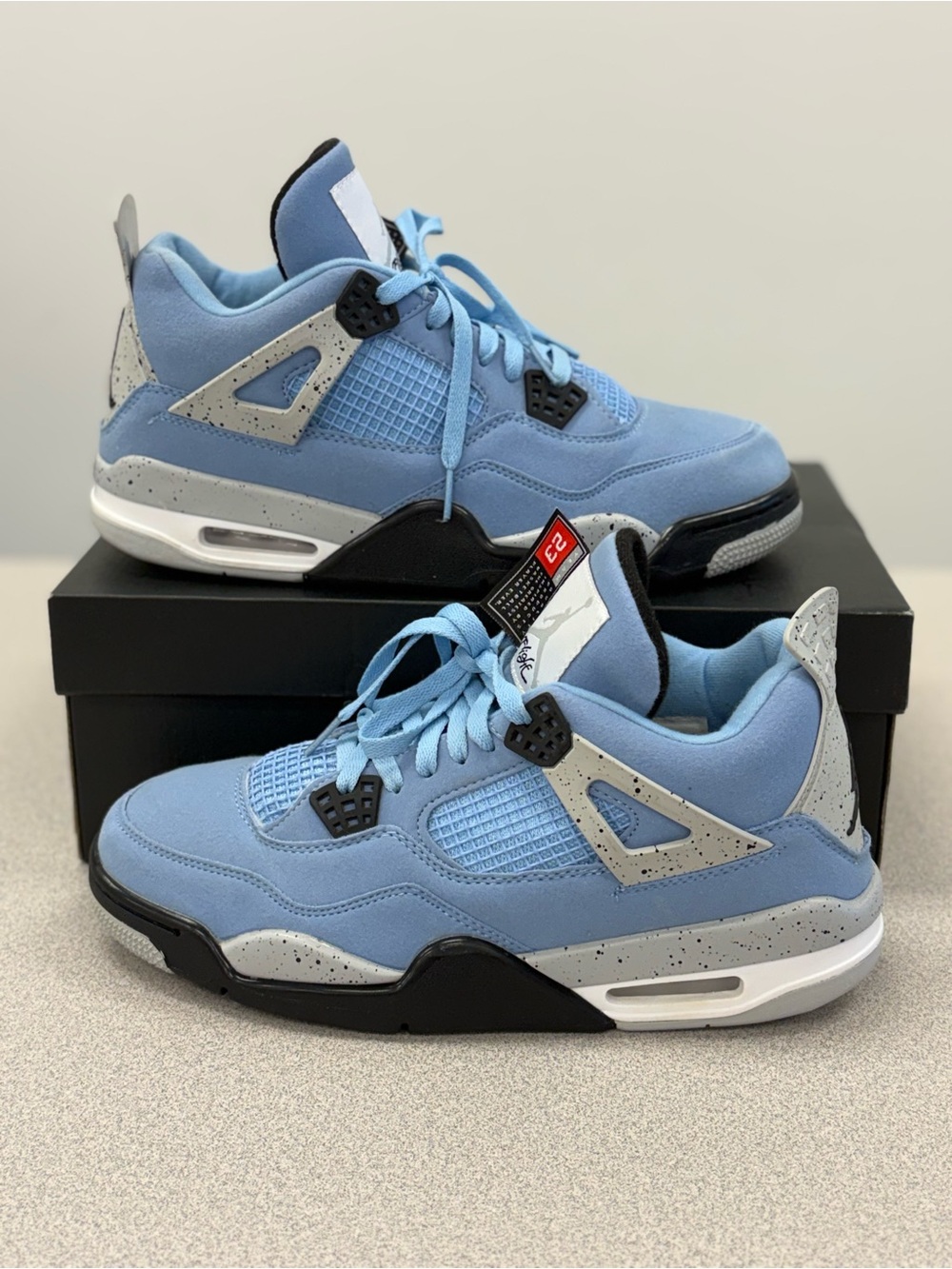 Size 10 - Jordan 4 Retro Mid University Blue Black White Suede sneakers.